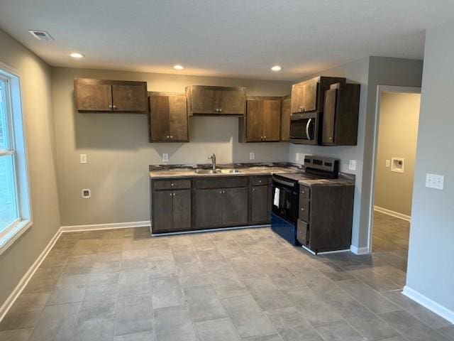 kitchen with dark brown cabinets, stainless steel appliances, and sink