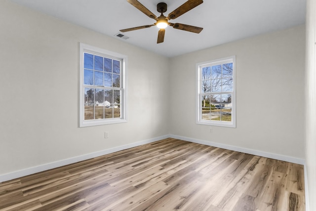 unfurnished room with ceiling fan and light wood-type flooring