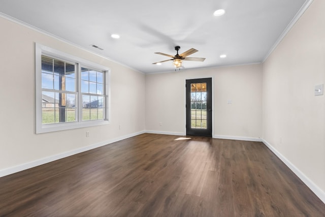 spare room featuring ceiling fan, ornamental molding, and dark hardwood / wood-style floors