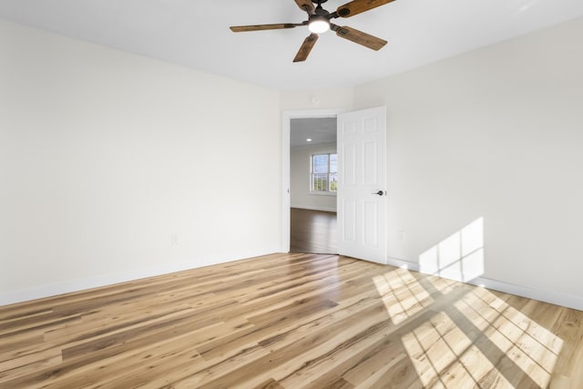 spare room with ceiling fan and light wood-type flooring