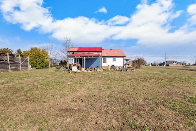 rear view of property with a lawn