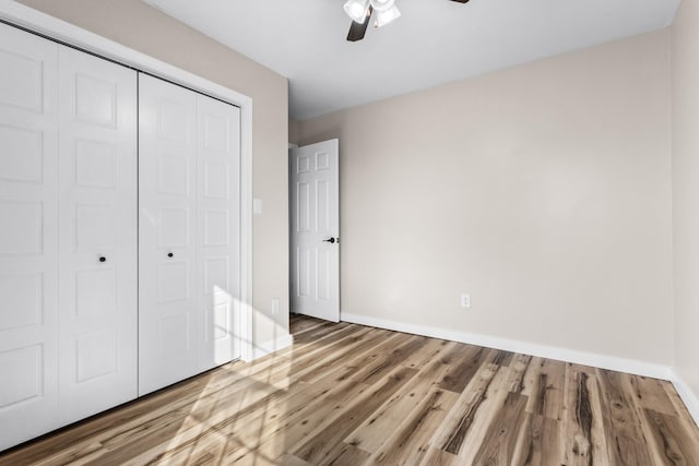 unfurnished bedroom with a closet, ceiling fan, and hardwood / wood-style floors