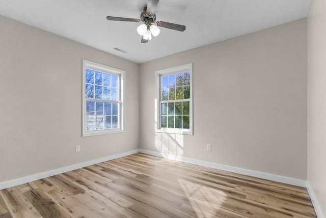 empty room with light hardwood / wood-style floors and ceiling fan