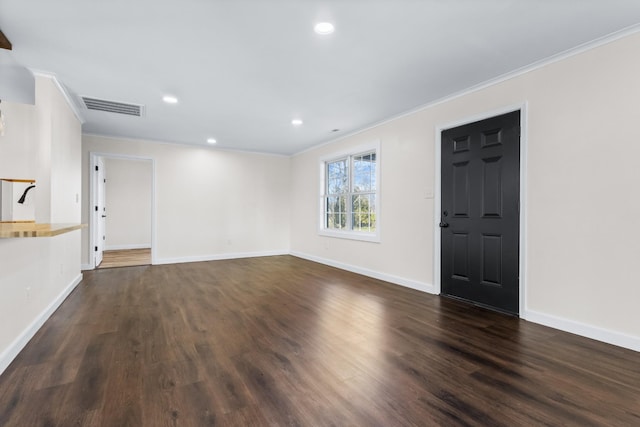 unfurnished living room with crown molding and dark hardwood / wood-style floors