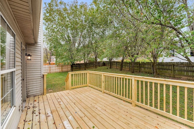 wooden terrace featuring a lawn