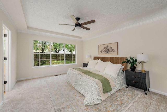 carpeted bedroom with a textured ceiling, a raised ceiling, and ceiling fan