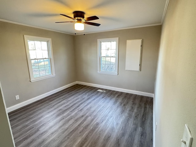 spare room featuring dark hardwood / wood-style floors, ceiling fan, and crown molding