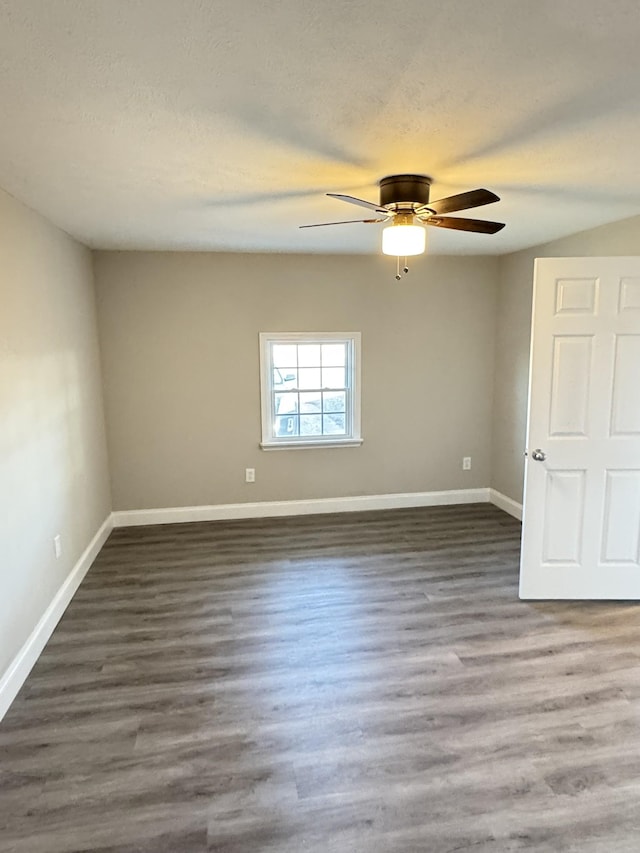 spare room featuring a textured ceiling, ceiling fan, and dark wood-type flooring