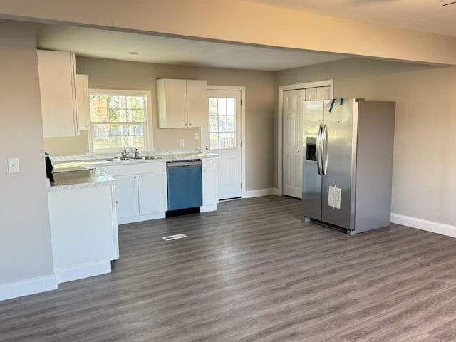 kitchen featuring sink, white cabinetry, stainless steel appliances, and dark wood-type flooring