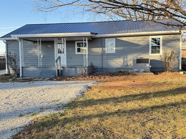 single story home featuring a front lawn and central AC unit