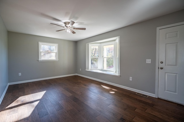 spare room with ceiling fan and dark wood-type flooring