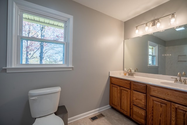 bathroom with tile patterned floors, vanity, and toilet