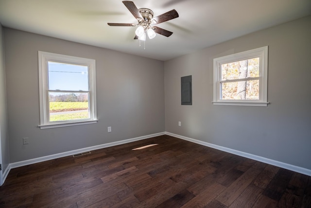 unfurnished room featuring ceiling fan, a healthy amount of sunlight, and dark hardwood / wood-style floors