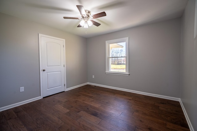 empty room featuring ceiling fan and dark hardwood / wood-style floors