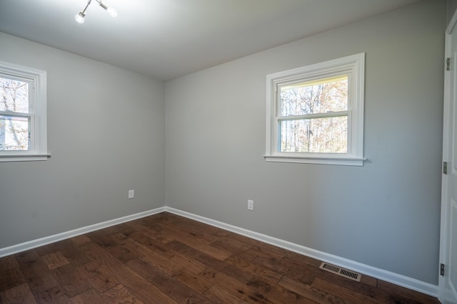 empty room featuring dark wood-type flooring