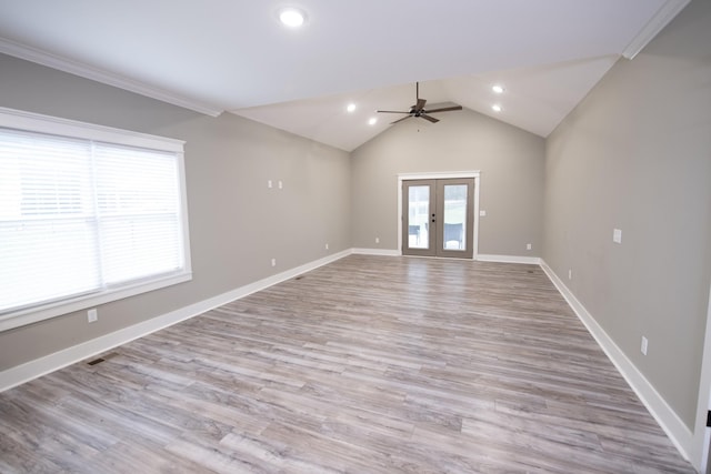 unfurnished room featuring french doors, ceiling fan, crown molding, light hardwood / wood-style flooring, and lofted ceiling