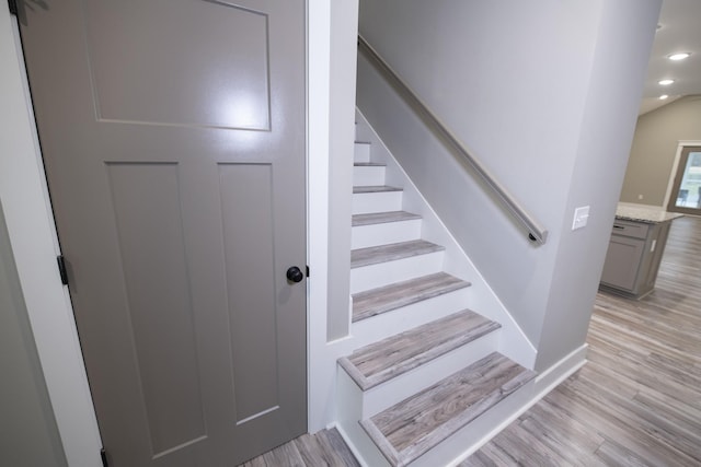 staircase featuring wood-type flooring