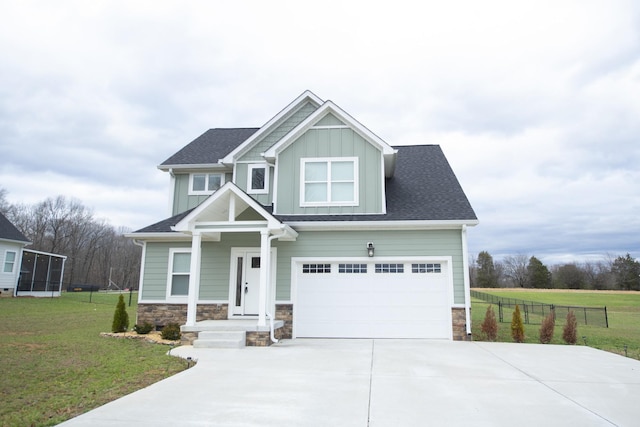 craftsman-style house with a front yard and a garage