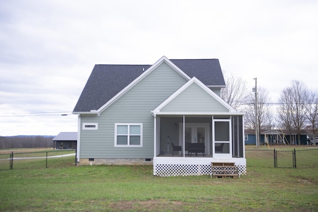 back of property featuring a lawn and a sunroom