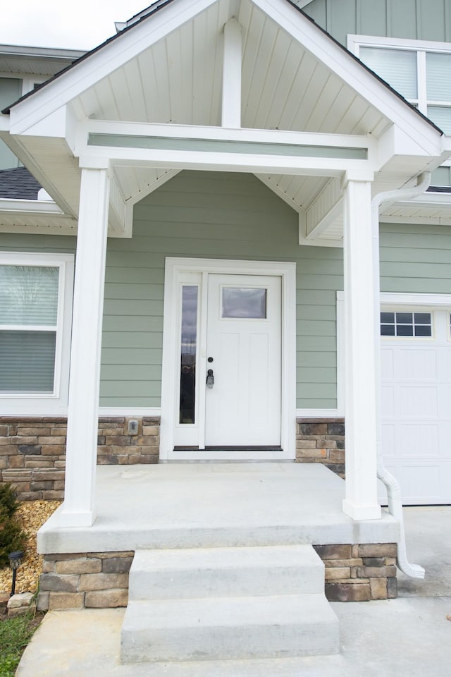 view of exterior entry with covered porch