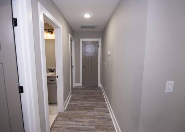 corridor with light hardwood / wood-style flooring