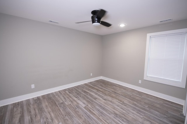 spare room with ceiling fan and wood-type flooring