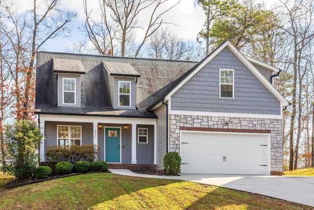 view of front of property with a front yard and a garage