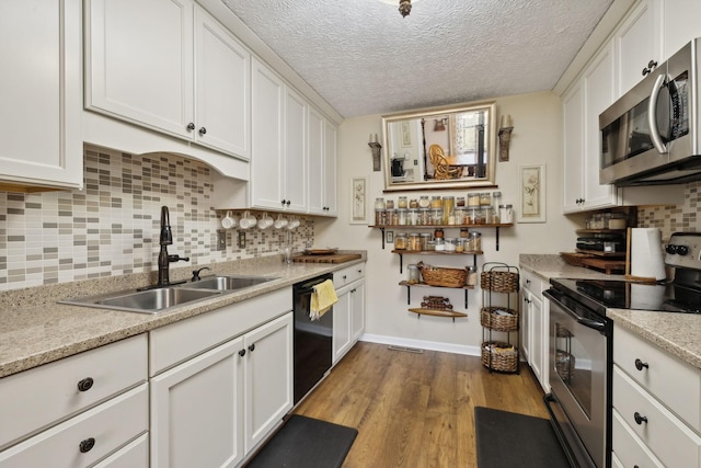 kitchen featuring white cabinets, sink, stainless steel appliances, and a textured ceiling