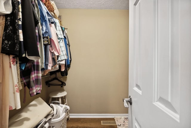 spacious closet featuring hardwood / wood-style flooring