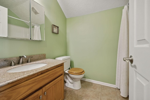 bathroom featuring tile patterned floors, vanity, toilet, and a textured ceiling