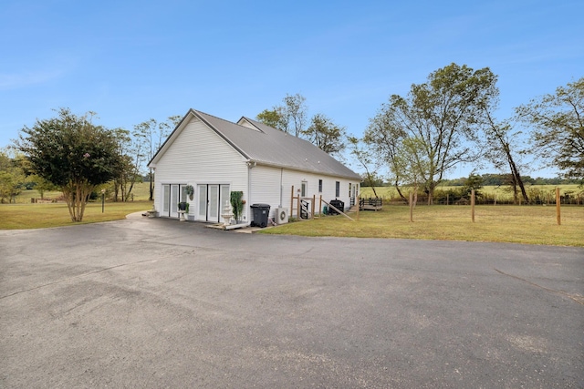 view of side of home with a lawn