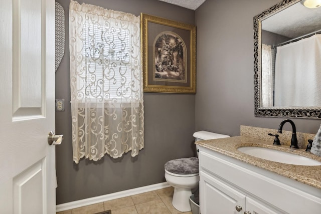 bathroom with tile patterned floors, vanity, and toilet