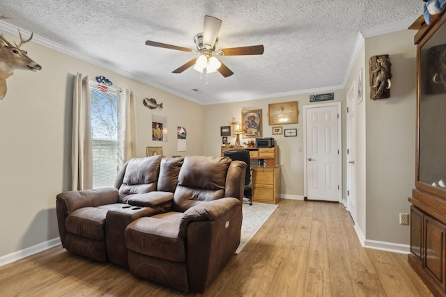 living room with a textured ceiling, light hardwood / wood-style flooring, ceiling fan, and ornamental molding