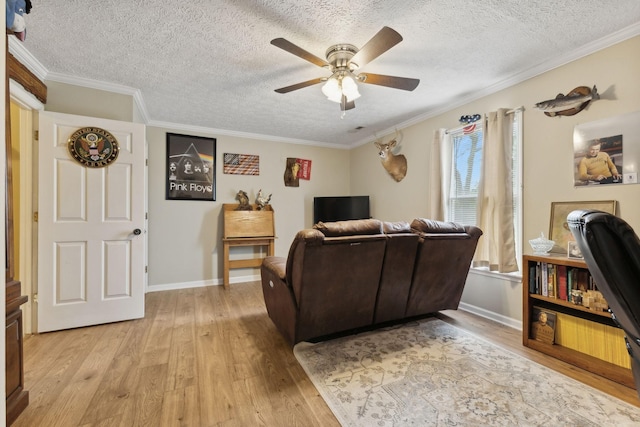 living room with a textured ceiling, light hardwood / wood-style floors, ceiling fan, and ornamental molding