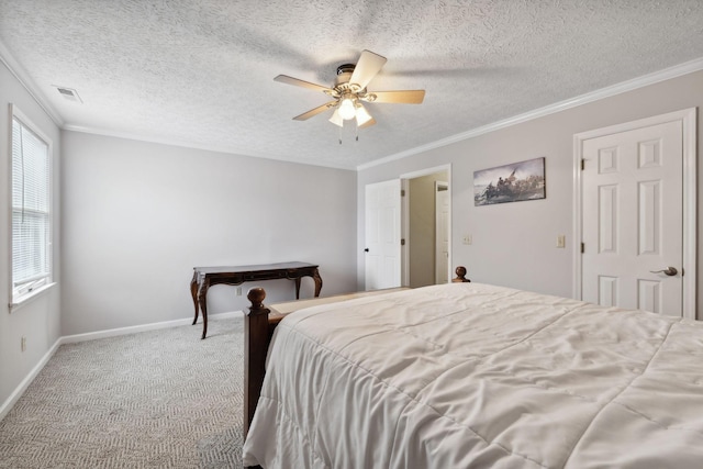 carpeted bedroom with a textured ceiling, ceiling fan, and crown molding