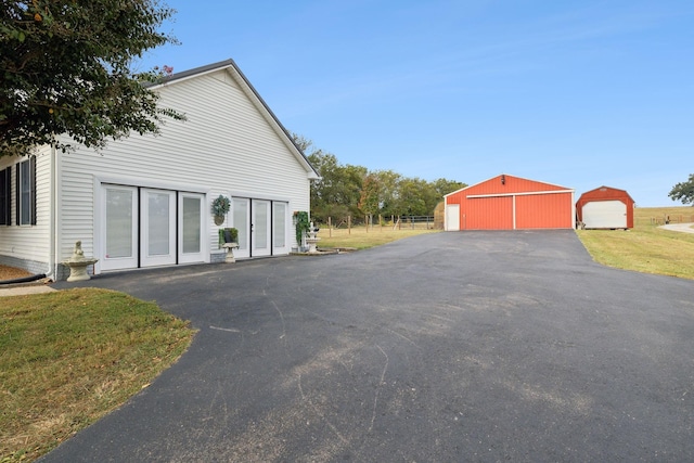 view of home's exterior featuring a yard, an outdoor structure, and a garage