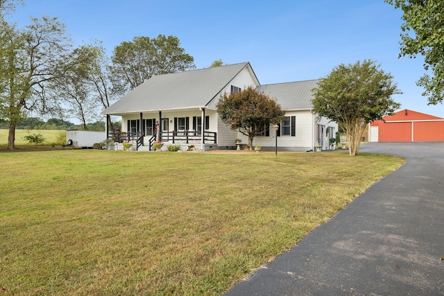 view of front of home with a porch, an outdoor structure, and a front lawn