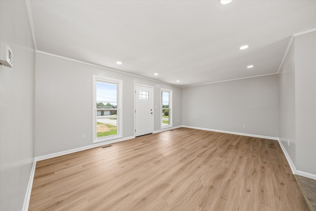 unfurnished room with crown molding and light hardwood / wood-style flooring