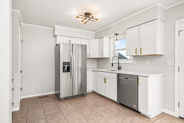 kitchen with pendant lighting, sink, light tile patterned floors, appliances with stainless steel finishes, and white cabinetry