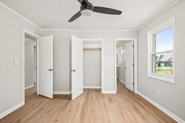 unfurnished bedroom featuring multiple windows, light hardwood / wood-style flooring, ceiling fan, and crown molding