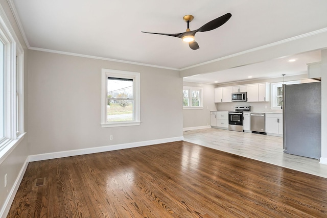 unfurnished living room featuring light hardwood / wood-style flooring, ceiling fan, ornamental molding, and sink