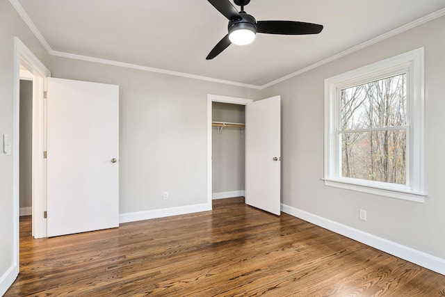 unfurnished bedroom featuring a closet, crown molding, ceiling fan, and dark wood-type flooring