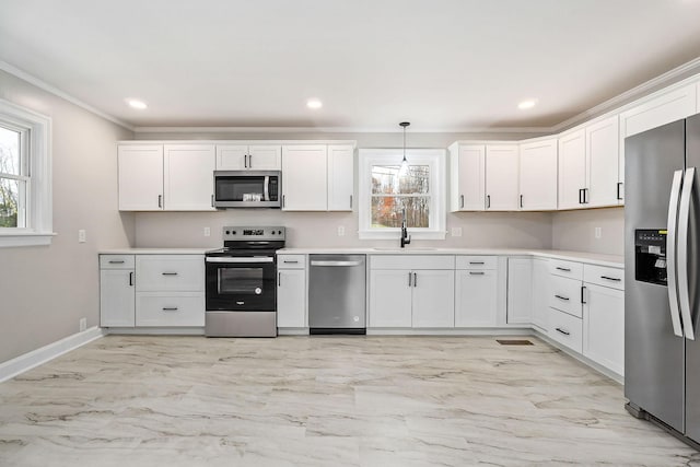 kitchen with white cabinetry, sink, pendant lighting, and appliances with stainless steel finishes