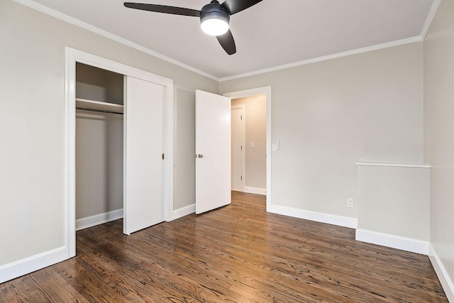 unfurnished bedroom with dark hardwood / wood-style flooring, a closet, ceiling fan, and ornamental molding