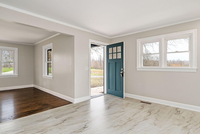 entrance foyer with plenty of natural light and crown molding