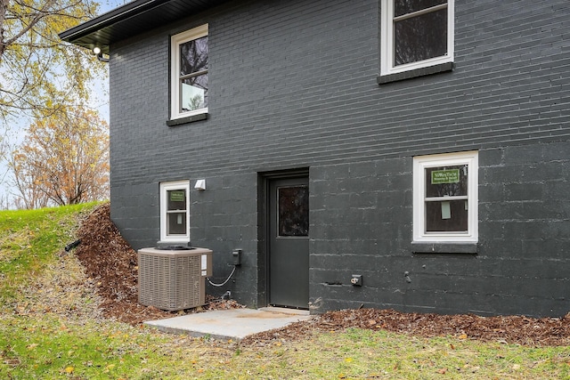 rear view of house featuring central air condition unit