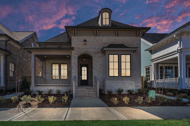 view of front of property with a porch and brick siding