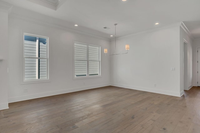 unfurnished room with baseboards, wood finished floors, crown molding, a healthy amount of sunlight, and recessed lighting