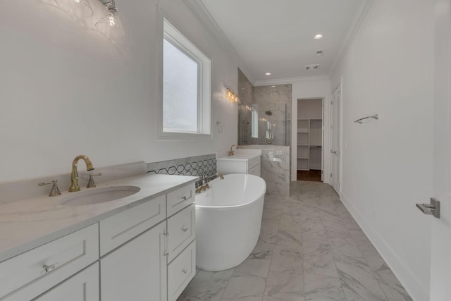 bathroom featuring a soaking tub, ornamental molding, marble finish floor, a shower stall, and a sink