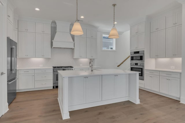 kitchen featuring custom exhaust hood, light countertops, light wood-style flooring, a sink, and high quality appliances